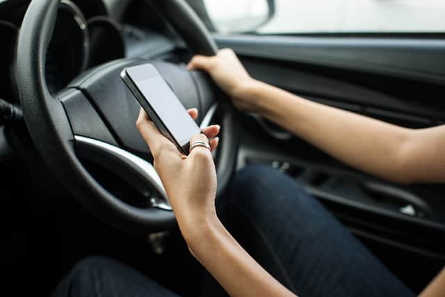 The new law bans any use of handheld devices while driving