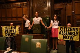 Handout photo taken with permission from the twitter feed of Extinction Rebellion of protesters who have superglued themselves around the Speaker's chair in the House of Commons chamber, as they call for a Citizen's Assembly. Picture date: Friday September 2, 2022.