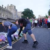Mourners gather laying flowers outside Windsor Castle in Berkshire following the announcement of the death of Queen Elizabeth II. Picture date: Thursday September 8, 2022.