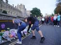 Mourners gather laying flowers outside Windsor Castle in Berkshire following the announcement of the death of Queen Elizabeth II. Picture date: Thursday September 8, 2022.