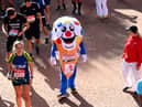 Members of the public finish during the 2021 Virgin Money London Marathon