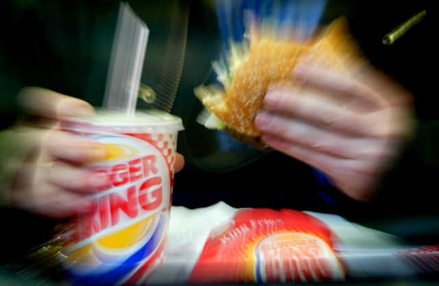  A man eats his lunch at a Burger King restaurant.