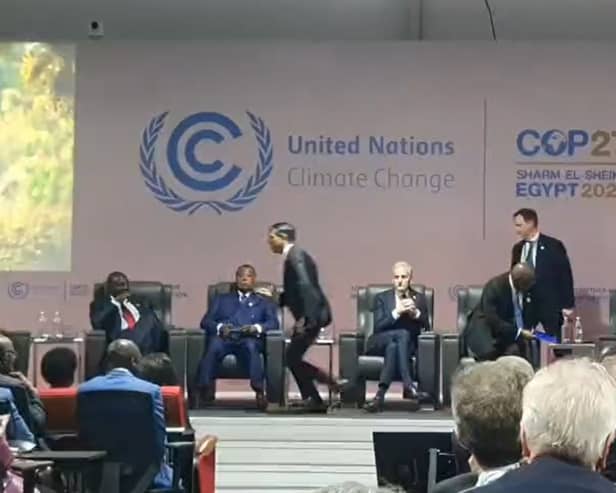 Prime Minister Rishi Sunak is seen running off the stage at an event at COP27 in Egypt.