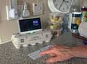 Pensioner Diane Skidmore examines her smart meter in London. 