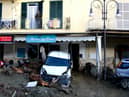 A man looks out from the balcony of his home in Casamicciola on November 27, 2022, following heavy rains that caused a landslide on the island of Ischia, southern Italy. - Italian rescuers were searching for a dozen missing people on the southern island of Ischia after a landslide killed at least one person, as the government scheduled an emergency meeting. A wave of mud and debris swept through the small town of Casamicciola Terme early Saturday morning, engulfing at least one house and sweeping cars down to the sea, local media and emergency services said. (Photo by Eliano IMPERATO / AFP) (Photo by ELIANO IMPERATO/AFP via Getty Images)