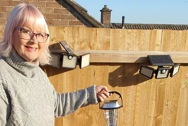 Kerry Collinson with a solar light and her foldable solar panel.