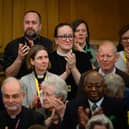 : Members of the General Synod react after blessings for same-sex couples was approved in a vote by the General Synod at The Church House.