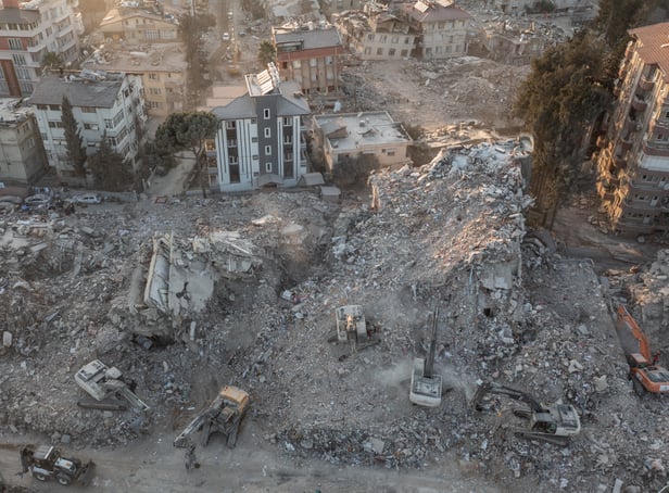 <p>An aerial view of work machines and diggers at the site of collapsed buildings on February 16, 2023 in Hatay, Turkey</p>