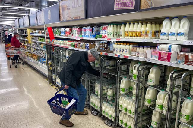 A customer shops for milk inside a Sainsbury's supermarket in east London on February 20, 2023.