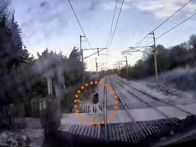 The video shows a man just inches from being hit by the speeding train.