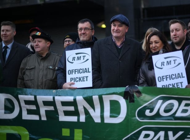 <p>RMT general secretary Mick Lynch (centre) on an RMT picket line during January’s strike (Photo by DANIEL LEAL/AFP via Getty Images)</p>