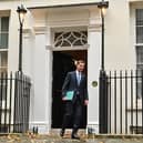 Britain's Chancellor of the Exchequer Jeremy Hunt walks out of Number 11 Downing Street 