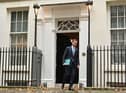 Britain's Chancellor of the Exchequer Jeremy Hunt walks out of Number 11 Downing Street 