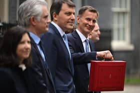 Britain’s Chancellor of the Exchequer Jeremy Hunt poses with the red Budget Box as he leaves 11 Downing Street in central London on March 15, 2023, to present the government’s annual budget to Parliament. (Photo by JUSTIN TALLIS / AFP) (Photo by JUSTIN TALLIS/AFP via Getty Images)