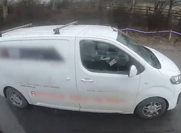 Motorists caught on camera watching a film while driving