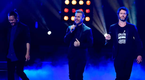 Take That bandmates Mark Owen, Gary Barlow and Howard Donald
