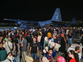 People evacuated from Sudan arrive at a military airport in Amman on 24 April 2023 (Photo: KHALIL MAZRAAWI/AFP via Getty Images)