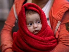 A Ukrainian woman holds her 3-month-old baby at the Western Railway Station as they flee Ukraine on March 9, 2022 in Budapest, Hungary. 
