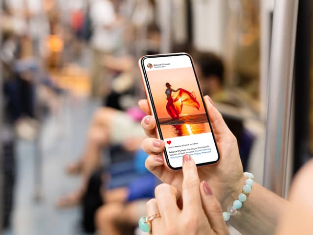 Woman on Metro scrolling through Instagram