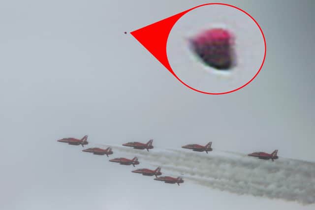 Simon Balson, 59, was taking pictures of the Red Arrows aerial display when he spotted the unusual object.  