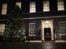 A Christmas tree stands illuminated outside number 10 Downing Street (Getty Images)