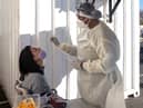 A woman receives a nasal swab, from a health worker wearing personal protective equipment (PPE), to be tested for COVID-19 at the Fourways Life Hospital in Johannesburg (Getty Images)