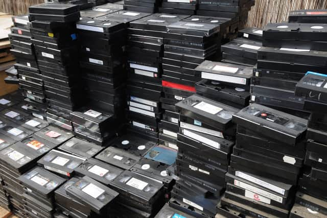 The pile of VHS video cassettes used to make a 12ft replica of the Titanic. See SWNS story SWTAPE: Teacher Chris Evans, who runs a charity for people with learning disabilities, decided to turn the group's unwanted tapes into an art installation. So a group of five students set about dismantling the hundreds of tapes - which each contain 36 separate parts when stripped apart. They then made the ship's body from cassettes and cases, the funnels from spools and the reams of tape inside was used for the sea.