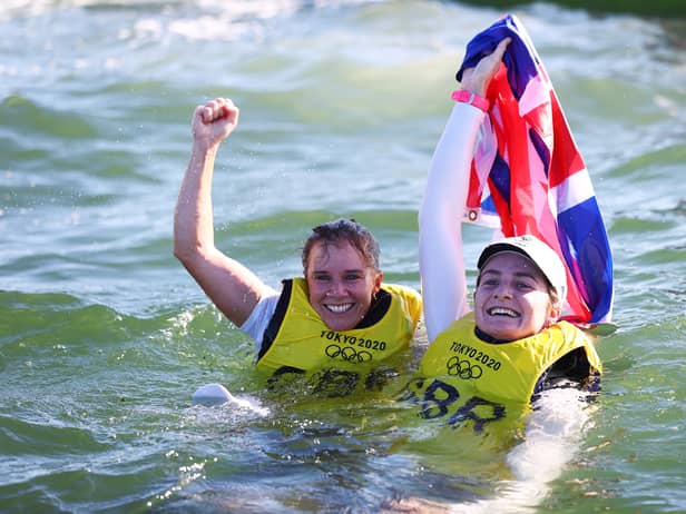Hannah Mills (L) and Eilidh McIntyre of Team Great Britain celebrate following the Women's 470 class medal race on day twelve of the Tokyo 2020 Olympic Games (Photo by Clive Mason/Getty Images)