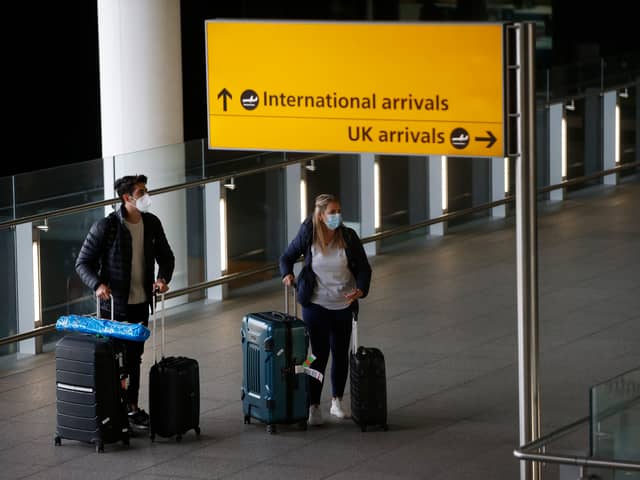 Travellers arrive at Heathrow Airport on January 17, 2021 in London (Photo by Hollie Adams/Getty Images)