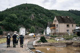 Firefighters inspect debris and damaged houses destroyed by the floods in western Germany (AFP/ Getty)