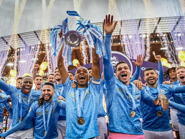 Fernandinho of Manchester City lifts the Premier League Trophy with team mates (Photo by Michael Regan/Getty Images)