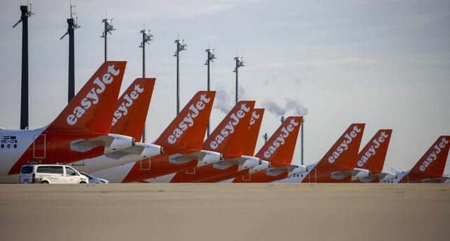 Easyjet planes are seen parked at the "Berlin Brandenburg Airport Willy Brandt" in Schoenefeld, southeast of Berlin (Photo by ODD ANDERSEN/AFP via Getty Images)