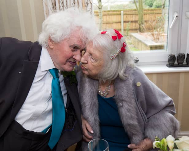 Joan Neininger & Ken Selway share a kiss at their wedding reception at Hannover Court, Cinderford, Gloucestershire. 