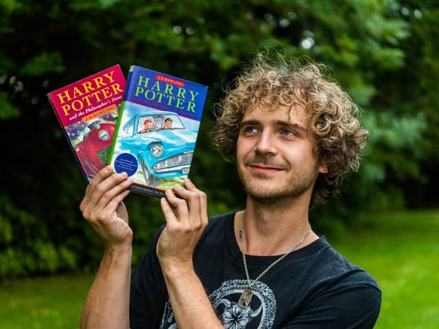 Max Roe with first edition copies of Harry Potter books his mum got him when he was young - one signed by JK Rowling could be worth £10,000.