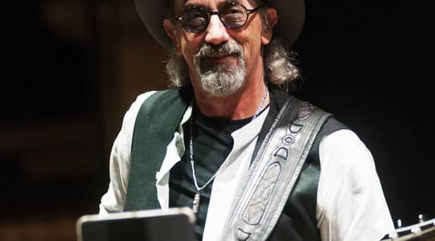 Jack Sonni was known as “the other guitarist” during the London band’s Brothers in Arms era. Source: https://commons.wikimedia.org/