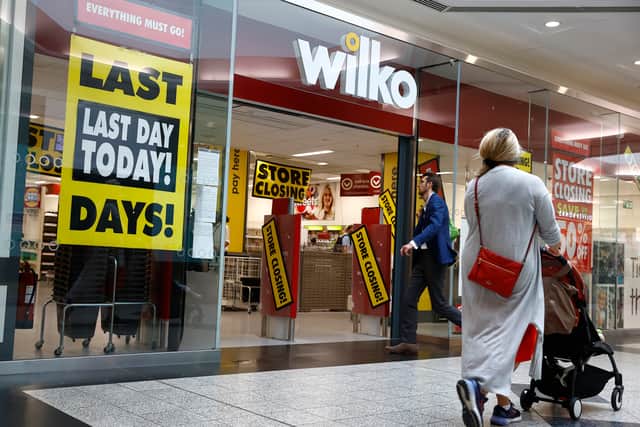 Shoppers walk past a Wilko store in Putney on September 12.