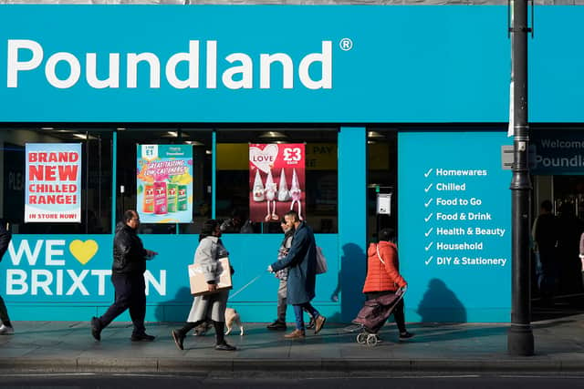 Shoppers walk past a Poundland shop in Brixton, south London.