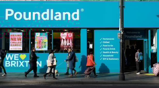 Shoppers walk past a Poundland shop in Brixton, south London.