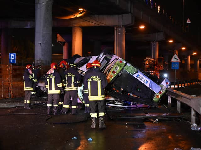 Firefighters work on the site of a bus accident on 3 October in Mestre, near Venice (Photo: MARCO SABADIN/AFP via Getty Images)