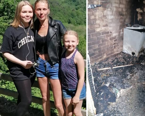 Kelly Feaviour and her daughters, and the burned-out tumble dryer Picture SWNS 