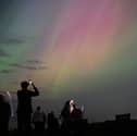 People visit St Mary's lighthouse in Whitley Bay to see the aurora borealis on 10 May 2024 (Photo: Ian Forsyth/Getty Images)