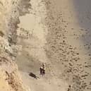Surfer rescued from beach after spelling “Help” on the sand.