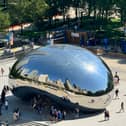 Chicago cityscape reflected in iconic Cloud Gate monument, known as 'The Bean'
