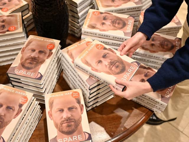 Prince Harry Spare: When does it come out in paperback and are there any new additions? A bookseller holds a copy of "Spare" by Britain's Prince Harry, Duke of Sussex, at Waterstones' flagship Piccadilly bookshop on the day of its release in London, on January 10, 2023