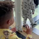 Mason Gee, 3, worried about his father Stephen Gee, 30, walking on a glass walkway