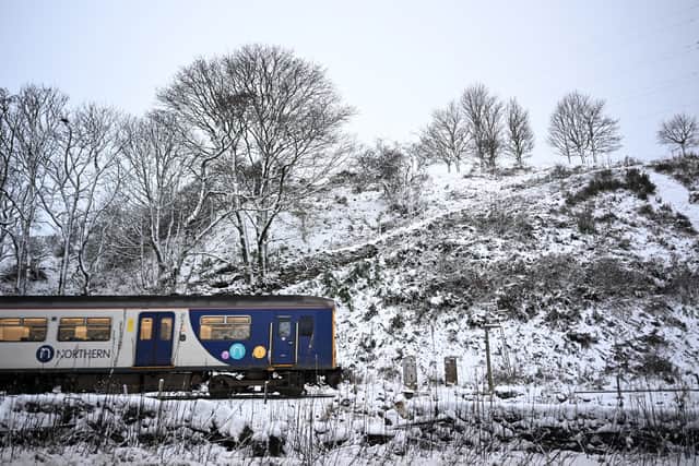 A Northern Rail train travels on tracks past snow in Buxton, northern England, on 19 November 2024 (Photo: PAUL ELLIS/AFP via Getty Images)