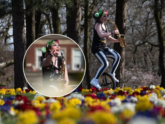 Rachel Ward plays the saxophone while riding a unicycle in Stanley Park