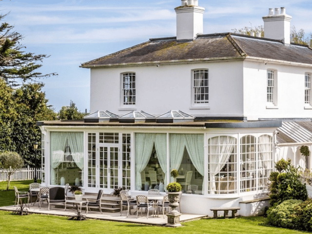 Merston House blends timeless Regency architecture with modern country living, complete with an orangery and sun-soaked patio for entertaining.