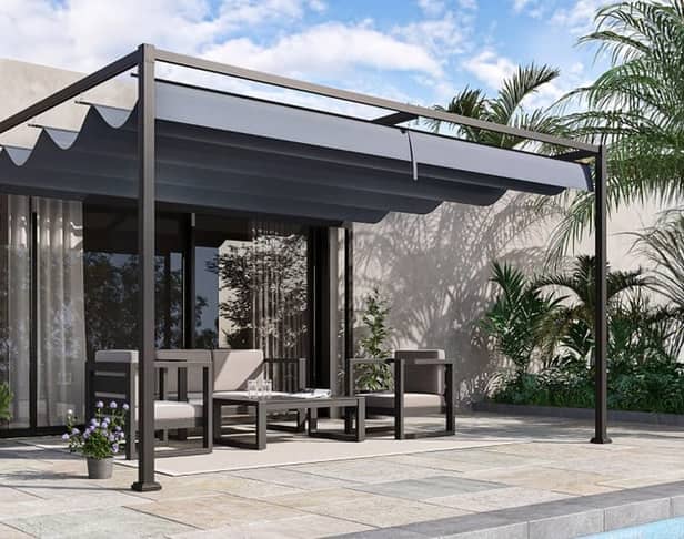 The pergola has a full-length retractable canopy to keep the sun off you