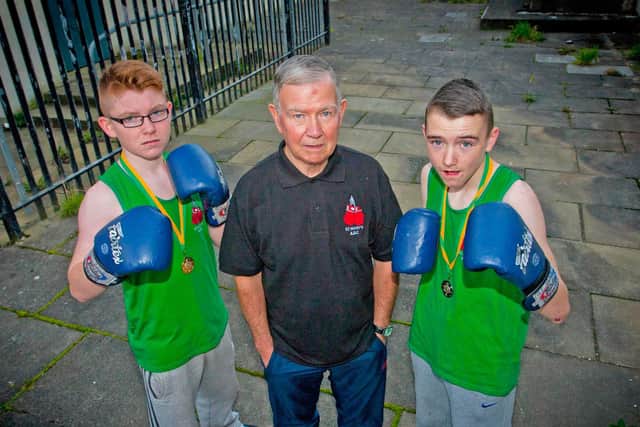 PROUD COACH . . . . St. Mary's ABC coach, Mickey Glackin pictured with the club's Donegal champions, Michael McLaughlin (54kg), left and Kevin Moore (50kg). He produced a long line of top boxing talent from the city.